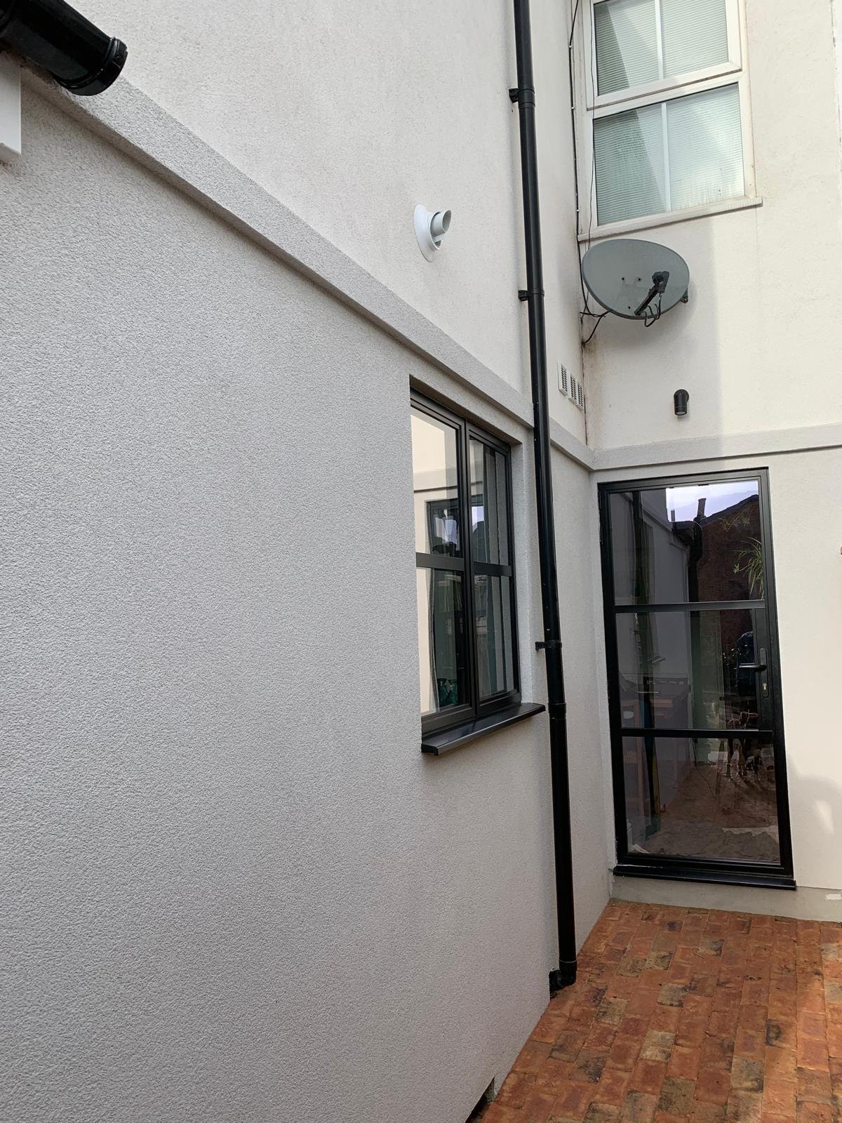 Damp-resistant render system for exterior wall protection by Monocrete Plastering Co